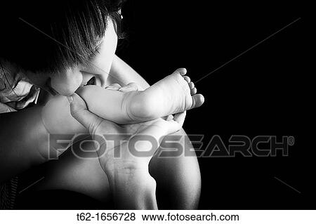Stock Photo - Young mother playing with her baby Tenderness and caresses Black and White. Fotosearch