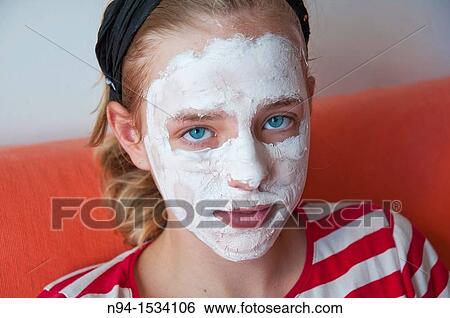 Young mother with her daughter at the time of relaxation Using the free time for personal care Using a facial mask to clean skin of the face View Large Photo Image Stock Photograph - Young mother with her daughter at the time of relaxation Using the free time for personal care Using a facial mask to clean skin of the face. Fotosearch