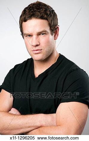 Young muscular strong fit healthy man with arms folded View Large Photo Image Stock Photography - Young muscular strong fit healthy man with arms folded. Fotosearch