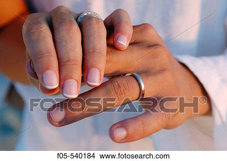 Young newly married couple showing their wedding rings. View Large Photo Image Picture - Young newly married couple showing their wedding rings.. Fotosearch