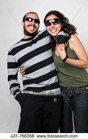 Young newlywed couple wearing shades smiling at the camera View Large Photo Image Stock Photo - Young newlywed couple wearing shades smiling at the camera. Fotosearch