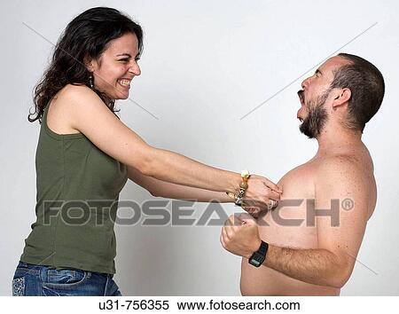 Young newlywed girl pinching her husband's nipples View Large Photo Image Stock Photography - Young newlywed girl pinching her husband's nipples. Fotosearch