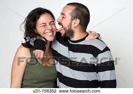 Young newlywed husband liking her wife on the cheek View Large Photo Image Stock Image - Young newlywed husband liking her wife on the cheek. Fotosearch