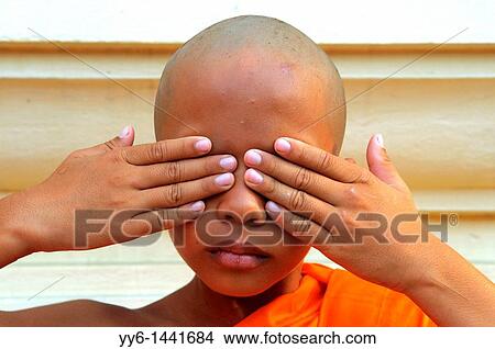 Young novice doing the three wise monkeys, proverbial principle during ordination ceremony, Wat Santithammaram, Thonburi, Bangkok, thailand View Large Photo Image Picture - Young novice doing the three wise monkeys, proverbial principle during ordination ceremony, Wat Santithammaram, Thonburi, Bangkok, thailand. Fotosearch