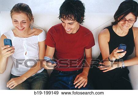Young people, cell phones View Large Photo Image Stock Photo - Young people, cell phones. Fotosearch