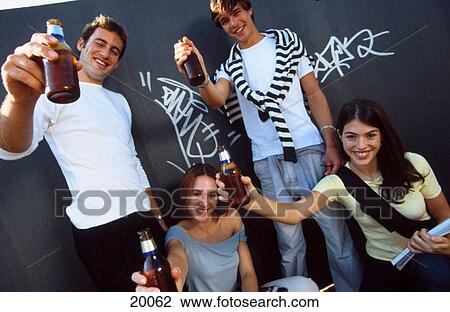 Young people drinking beer View Large Photo Image Stock Image - Young people drinking beer. Fotosearch