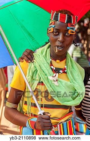Young People From The Banna Tribe Stand Under Umbrellas At The Thursday Market In Key Afar, Omo Valley, Ethiopia. View Large Photo Image Stock Photo - Young People From The Banna Tribe Stand Under Umbrellas At The Thursday Market In Key Afar, Omo Valley, Ethiopia.. Fotosearch