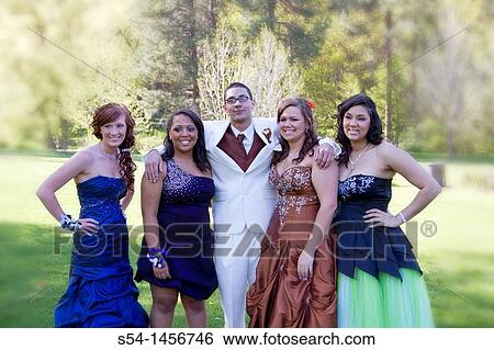 Stock Photograph - Young people in prom clothes at the park.. Fotosearch