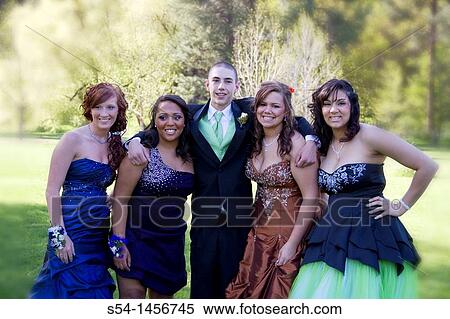 Stock Photography - Young people in prom clothes at the park.. Fotosearch