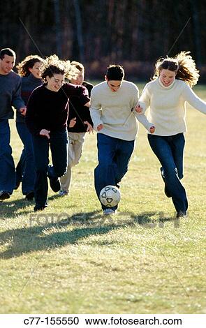 Young people playing football View Large Photo Image Stock Image - Young people playing football. Fotosearch