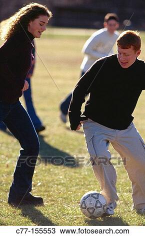 Young people playing football View Large Photo Image Stock Image - Young people playing football. Fotosearch