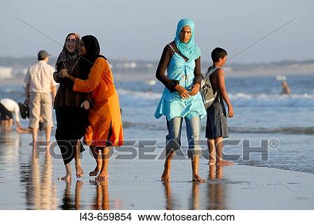 Young people strolling on the beach. Agadir. Morocco. View Large Photo Image Picture - Young people strolling on the beach. Agadir. Morocco.. Fotosearch