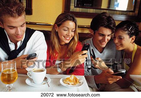 Young people with cell phones View Large Photo Image Stock Image - Young people with cell phones. Fotosearch