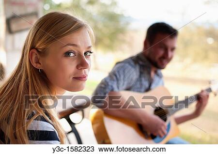 Stock Image - Young people - woman and man enjoying house music. Fotosearch