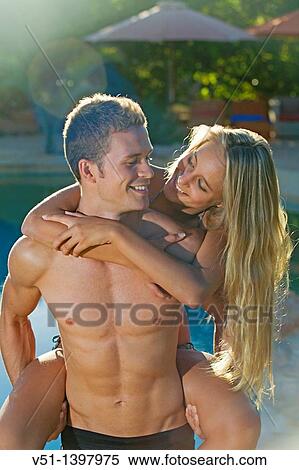 Young playful couple by the pool View Large Photo Image Stock Photography - Young playful couple by the pool. Fotosearch