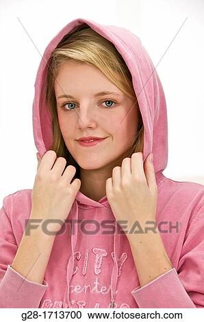 young pretty blond woman holding the hood of her pink jogging over her head to protect herself from the cold View Large Photo Image Stock Image - young pretty blond woman holding the hood of her pink jogging over her head to protect herself from the cold. Fotosearch