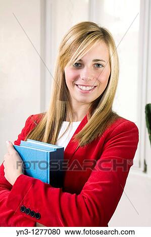 Young pretty student holding books View Large Photo Image Stock Image - Young pretty student holding books. Fotosearch