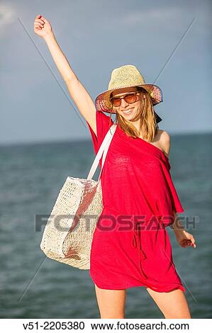 Young pretty woman arriving at the beach View Large Photo Image Stock Image - Young pretty woman arriving at the beach. Fotosearch