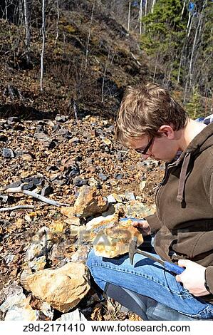 Stock Image - Young prospector exploring for minerals, Smithers, British Columbia.. Fotosearch