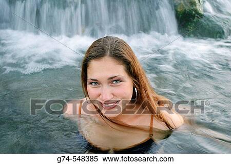Stock Photography - Young Russian woman enjoying hot springs in Yellowstone National Park, Wyoming. USA.. Fotosearch