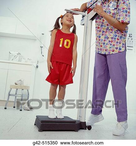 Young schoolgirl getting physical exam for playing school sports. View Large Photo Image Stock Image - Young schoolgirl getting physical exam for playing school sports.. Fotosearch
