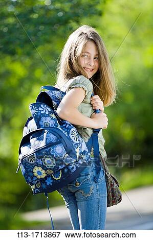 Young schoolgirl in the park View Large Photo Image Stock Photo - Young schoolgirl in the park. Fotosearch