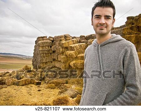 Stock Photo - Young shepherd, straw bales in background. Albacete province, Castile-La Mancha, Spain. Fotosearch