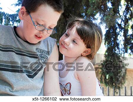 Young sister of 5 looks admiringly at her older brother of 7 model release available View Large Photo Image Stock Image - Young sister of 5 looks admiringly at her older brother of 7 model release available. Fotosearch