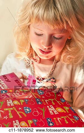 young six year old girl opening present View Large Photo Image Stock Image - young six year old girl opening present. Fotosearch
