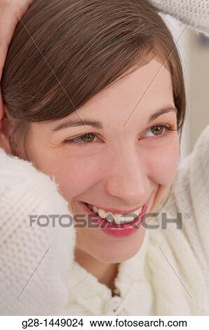 Young smiling woman in white woolen cardigan View Large Photo Image Picture - Young smiling woman in white woolen cardigan. Fotosearch