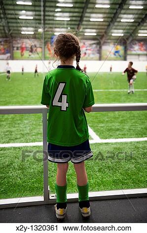 Young soccer player watches an indoor game View Large Photo Image Stock Image - Young soccer player watches an indoor game. Fotosearch