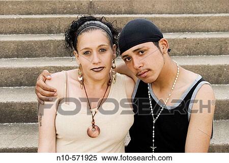 Young Spanish couple, the woman eight months pregnant, sitting together View Large Photo Image Stock Photography - Young Spanish couple, the woman eight months pregnant, sitting together. Fotosearch