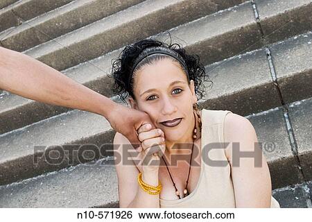 Stock Photograph - Young Spanish woman, eight months pregnant, holding the hand of her husband, who is not in the shot. Fotosearch