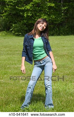 Young Spanish/Asian woman dancing alone at a park. View Large Photo Image Stock Image - Young Spanish/Asian woman dancing alone at a park.. Fotosearch