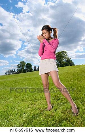 Young Spanish/Asian woman, in pigtails, posing at a park View Large Photo Image Stock Photograph - Young Spanish/Asian woman, in pigtails, posing at a park. Fotosearch