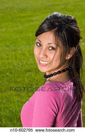 Young Spanish/Asian woman posing at a park View Large Photo Image Stock Photography - Young Spanish/Asian woman posing at a park. Fotosearch