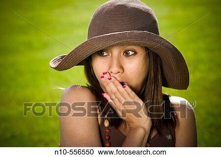 Young Spanish/Asian woman, wearing a hat, posing at a park. View Large Photo Image Stock Image - Young Spanish/Asian woman, wearing a hat, posing at a park.. Fotosearch