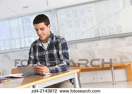 Young student using digital tablet View Large Photo Image Stock Image - Young student using digital tablet. Fotosearch