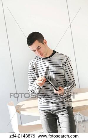 Young student using digital tablet View Large Photo Image Stock Photography - Young student using digital tablet. Fotosearch