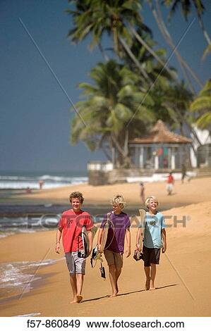 Young surfers walking along Hikkaduwa Beach, Sri Lanka View Large Photo Image Stock Photo - Young surfers walking along Hikkaduwa Beach, Sri Lanka. Fotosearch