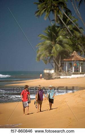 Young surfers walking along Hikkaduwa Beach, Sri Lanka View Large Photo Image Stock Photograph - Young surfers walking along Hikkaduwa Beach, Sri Lanka. Fotosearch