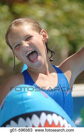 Young swims in a backyard pool. View Large Photo Image Stock Image - Young swims in a backyard pool.. Fotosearch
