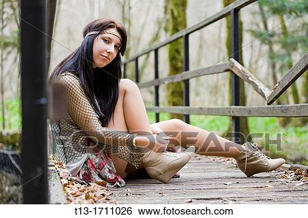 Young teen hippie style tying shoe laces View Large Photo Image Stock Photograph - Young teen hippie style tying shoe laces. Fotosearch