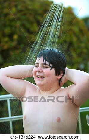 Picture - young teen in outdoor shower. Fotosearch