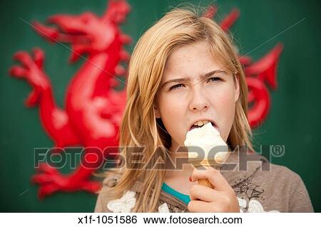 Young teenage girl eating icecream, welsh red dragon in the background View Large Photo Image Stock Photograph - Young teenage girl eating icecream, welsh red dragon in the background. Fotosearch