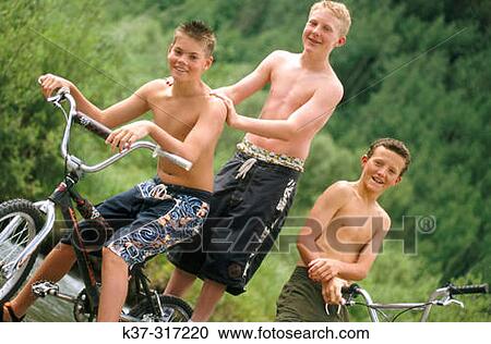 Young teenage youths on mountain bikes, wearing swimming trunks View Large Photo Image Stock Image - Young teenage youths on mountain bikes, wearing swimming trunks. Fotosearch