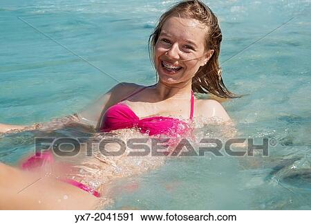 Stock Image - Young teenager at the beach.. Fotosearch