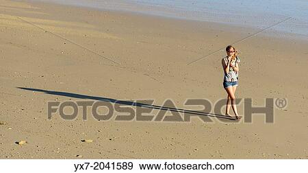 Stock Photo - Young teenager at the beach.. Fotosearch