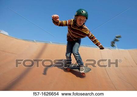 Young teenager skateboarding in a bowl View Large Photo Image Picture - Young teenager skateboarding in a bowl. Fotosearch