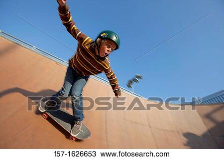 Young teenager skateboarding in a bowl View Large Photo Image Stock Image - Young teenager skateboarding in a bowl. Fotosearch